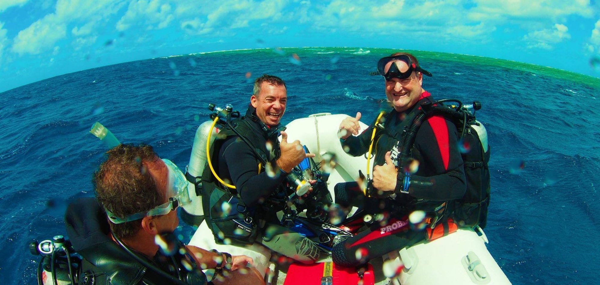 Cairns liveaboard scuba diving - Divers prepare to enter the water to scuba dive on the Great Barrier Reef, Queensland