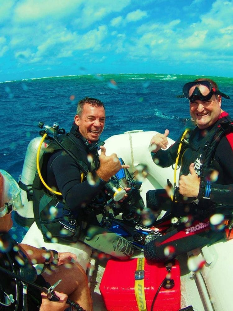 Cairns liveaboard scuba diving - Divers prepare to enter the water to scuba dive on the Great Barrier Reef, Queensland